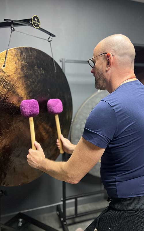 David playing a gong